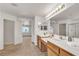 Bright bathroom featuring double sinks and vanity with tile countertops at 10508 Waking Cloud Ave, Las Vegas, NV 89129