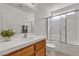 Well-lit bathroom features a combination shower and tub plus a vanity with sink at 10508 Waking Cloud Ave, Las Vegas, NV 89129