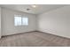 Carpeted bedroom featuring a window with a view of the city at 10508 Waking Cloud Ave, Las Vegas, NV 89129