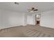Spacious bedroom leading to a bath with neutral walls and ceiling fan at 10508 Waking Cloud Ave, Las Vegas, NV 89129