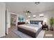Cozy bedroom with a king bed, soft rug, and mounted TV at 10508 Waking Cloud Ave, Las Vegas, NV 89129