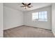 Carpeted bedroom featuring a ceiling fan and natural light at 10508 Waking Cloud Ave, Las Vegas, NV 89129