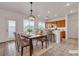 Dining area with table set and adjacent kitchen featuring tile floors and natural light at 10508 Waking Cloud Ave, Las Vegas, NV 89129