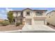 Charming two-story home with a two-car garage and desert landscaping at 10508 Waking Cloud Ave, Las Vegas, NV 89129