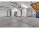 Spacious three car garage includes shelving, overhead lighting, and high ceilings at 10508 Waking Cloud Ave, Las Vegas, NV 89129