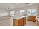 Open concept kitchen features an island with tiled countertop and an adjacent living area at 10508 Waking Cloud Ave, Las Vegas, NV 89129
