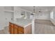 Open concept kitchen with tile floors and countertops leading into the living room at 10508 Waking Cloud Ave, Las Vegas, NV 89129