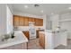 Kitchen with white countertops, wood cabinets, tile floors, and modern appliances at 10508 Waking Cloud Ave, Las Vegas, NV 89129