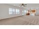 Open-concept living area with tile floors, multiple windows, and a view of the kitchen at 10508 Waking Cloud Ave, Las Vegas, NV 89129