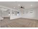 Spacious living room featuring neutral carpet, ceiling fan and recessed lighting at 10508 Waking Cloud Ave, Las Vegas, NV 89129