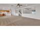 Spacious living area featuring an open kitchen, carpeted floors, and a staircase at 10508 Waking Cloud Ave, Las Vegas, NV 89129