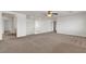 Lofted living room area with neutral carpet and a staircase leading to the lower level at 10508 Waking Cloud Ave, Las Vegas, NV 89129