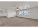 Spacious living area with neutral carpeting and multiple windows for natural lighting at 10508 Waking Cloud Ave, Las Vegas, NV 89129