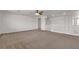 Bright living room with neutral carpet, white walls, and a ceiling fan at 10508 Waking Cloud Ave, Las Vegas, NV 89129