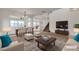 Staged open-concept living room with stylish furnishings and ample natural light at 10508 Waking Cloud Ave, Las Vegas, NV 89129