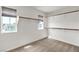This carpeted walk-in closet boasts ample shelving and two windows for natural light at 10508 Waking Cloud Ave, Las Vegas, NV 89129