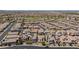 Expansive aerial view of a well-planned community, showcasing a mix of homes and green spaces at 1105 Strada Pecei, Henderson, NV 89011