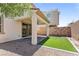 Cozy backyard featuring a covered patio, artificial turf area, and low-maintenance landscaping at 1105 Strada Pecei, Henderson, NV 89011