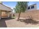Private backyard with desert landscaping, brick wall, covered patio and a small artificial turf area at 1105 Strada Pecei, Henderson, NV 89011