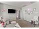 Spacious bedroom with a cozy seating area, soft carpet, and ample natural light at 1105 Strada Pecei, Henderson, NV 89011