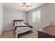 Bright bedroom with plush carpeting, a ceiling fan, and a large window at 1105 Strada Pecei, Henderson, NV 89011