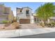 Charming stucco home with a two-car garage and beautifully designed desert landscaping at 1105 Strada Pecei, Henderson, NV 89011