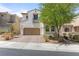 Charming stucco home with a two-car garage and beautifully designed desert landscaping at 1105 Strada Pecei, Henderson, NV 89011