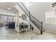 Inviting foyer with tile flooring, staircase, and a view into the living area with natural lighting at 1105 Strada Pecei, Henderson, NV 89011