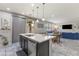 Open-concept kitchen with island, stainless steel dishwasher, seamlessly flowing into the dining and living areas at 1105 Strada Pecei, Henderson, NV 89011