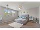 Serene bedroom with a comfortable bed, ceiling fan, and large windows for natural light at 1105 Strada Pecei, Henderson, NV 89011