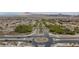 Picturesque street view showcases palm-lined median and community entrance amidst desert landscape at 1105 Strada Pecei, Henderson, NV 89011