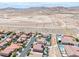 Expansive aerial shot showcasing a residential community nestled against a scenic mountain backdrop at 11275 Gammila Dr, Las Vegas, NV 89141