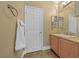 Well-lit bathroom featuring a double sink vanity, granite countertop, and a decorative towel rack at 11275 Gammila Dr, Las Vegas, NV 89141