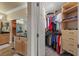 Bathroom featuring walk-in closet, double sinks, and neutral tones at 11275 Gammila Dr, Las Vegas, NV 89141