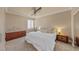 Serene bedroom with a plush white bed, complemented by dark wood nightstands and a ceiling fan at 11275 Gammila Dr, Las Vegas, NV 89141