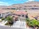Beautiful two-story home featuring a red tile roof, lush landscaping, and a three-car garage at 11275 Gammila Dr, Las Vegas, NV 89141