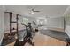 Spacious home gym with hardwood floors, recessed lighting, and a variety of fitness equipment at 11275 Gammila Dr, Las Vegas, NV 89141