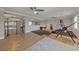 Bright home gym featuring hardwood floors, recessed lighting, exercise equipment and a large mirror at 11275 Gammila Dr, Las Vegas, NV 89141
