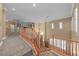 Bright hallway with neutral tones, wood railings, carpeted floors and plenty of natural light at 11275 Gammila Dr, Las Vegas, NV 89141
