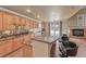 Spacious kitchen featuring an eat-in island, gas cooktop, and direct access to backyard at 11275 Gammila Dr, Las Vegas, NV 89141