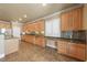 Traditional style kitchen boasts granite countertops, mosaic backsplash, and light wood cabinetry at 11275 Gammila Dr, Las Vegas, NV 89141