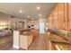 Open kitchen features granite countertops, island with seating, and stainless steel appliances at 11275 Gammila Dr, Las Vegas, NV 89141
