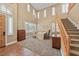 Sunlit living room boasting high ceilings, modern decor, and a staircase at 11275 Gammila Dr, Las Vegas, NV 89141