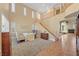Spacious living room featuring high ceilings, staircase, and fireplace in the background at 11275 Gammila Dr, Las Vegas, NV 89141