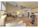 Large living room with vaulted ceilings, a fireplace, and an open layout to the kitchen and breakfast bar at 11275 Gammila Dr, Las Vegas, NV 89141