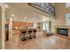 Open-concept living area with fireplace, breakfast bar, and upper-level loft space at 11275 Gammila Dr, Las Vegas, NV 89141