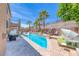 Inviting backyard pool features a sun shelf, palm trees and lounge seating for relaxation and enjoying the outdoors at 11275 Gammila Dr, Las Vegas, NV 89141