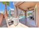 Inviting outdoor living space with a covered patio, swimming pool, and lounge area at 11275 Gammila Dr, Las Vegas, NV 89141