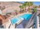 Aerial view of a private backyard oasis with a sparkling pool, spa, and lush landscaping at 11275 Gammila Dr, Las Vegas, NV 89141