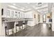 Chic bar area with sleek countertops, glass-front cabinets, stylish seating, and modern finishes throughout at 12217 Tempestad Ave, Las Vegas, NV 89138